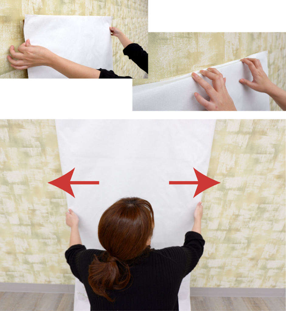 女性が襖紙を両手で丁寧に貼っている作業中の画像
